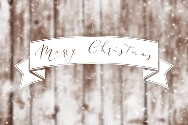 Merry Christmas banner over grunge wood planks with snow flakes falling on. Christmas background