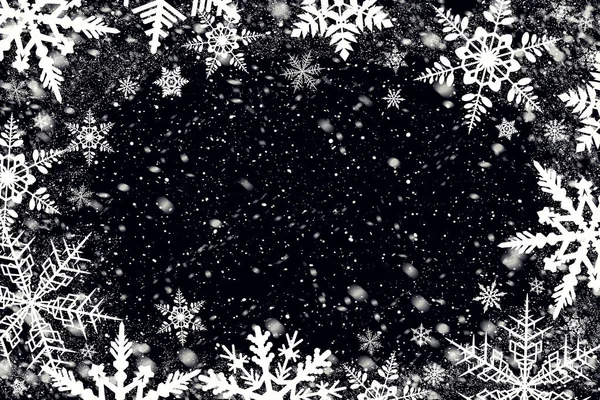 Snow flakes over black background for your photo. Just switch screen blending mode.