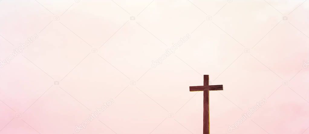 Wooden cross over abstract sky background. Christian concept