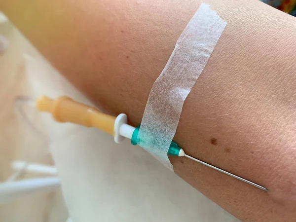 a needle in the vein, IV fluids, an injection into a vein