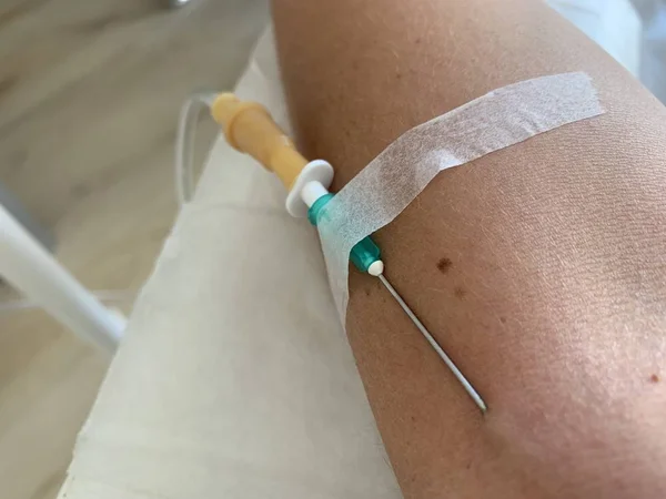 a needle in the vein, IV fluids, an injection into a vein