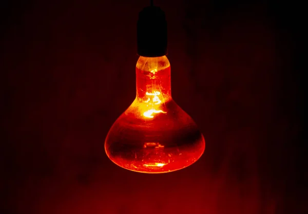 Red round lamp shines in the dark — Stock Photo, Image