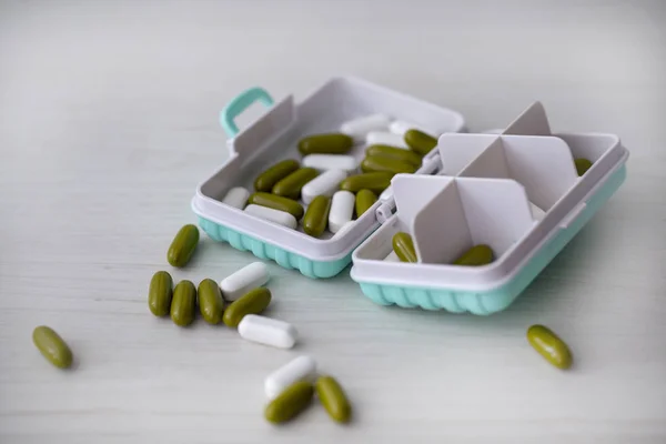 pill box for storing pills on wooden surface