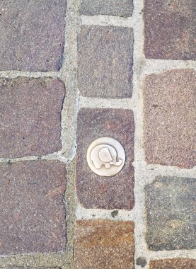 Şirin bir fili olan pirinç levha Chambery turistik yaya yolunda bir simgeyi imzalamak için.