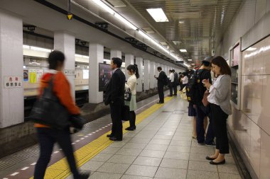 Tokyo, Japonya - 8 Mayıs 2012: Tokyo Tokyo Metro istasyonunda insanlar bekler. Fazla 3.1 milyar yıllık yolcu sürmek ile Tokyo metro sistemi en yoğun dünya çapında olduğunu.