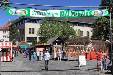 NUREMBERG, GERMANY - MAY 6, 2018: People visit Spargeltage celebration in Nuremberg, Germany. Spargeltage event means Asparagus Days and celebrates the asparagus harvest time. clipart
