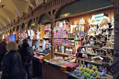 Krakow, Polonya - 12 Nisan 2014: satıcı satar Lehçe geleneksel el sanatları Hatıra Eşyası bez Salonu'nda, krakow. sukiennice bezi hall 1978 yılından bu yana unesco dünya mirası bir parçasıdır.