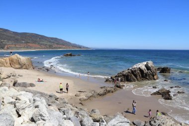 MALIBU, USA - APRIL 6, 2014: People visit Leo Carillo State Beach near Malibu, California. California State Park system manages 280 properties including state beaches. clipart