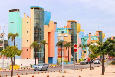 ALBUFEIRA, PORTUGAL - MAY 30, 2018: Colorful architecture by the marina of Albufeira, Portugal. The town is a popular tourism destination and has significant expat population. clipart