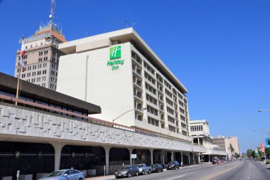 FRESNO, UNITED STATES - APRIL 12, 2014: Holiday Inn hotel in Fresno, California. Holiday Inn is a part of InterContinental Hotels Group and has 3,414 locations. clipart