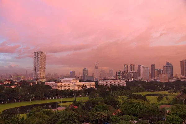 Manila city skyline in sunset light in Philippines. Ermita and Paco districts seen from Intramuros.