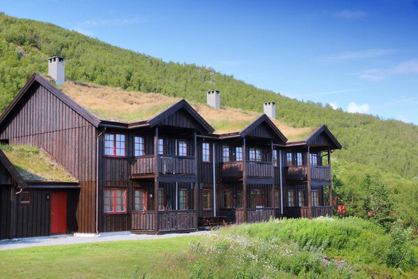 TELEMARK, NORWAY - JULY 15, 2015: Traditional wooden hotel with grass turf roof in Haukelifjell mouintains, Telemark county, Norway. Sod roofs or turf roofs are a popular solution in Scandinavia.