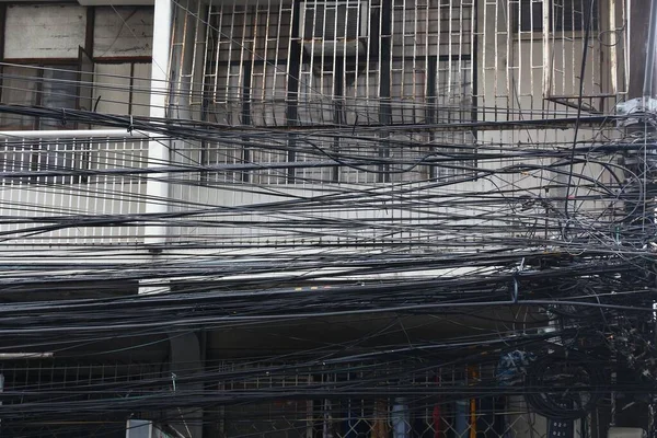 City cable chaos in Asia - tangled mess of cables in Manila, Philippines.