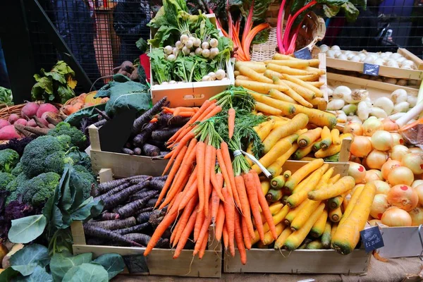 Varieties of carrots: black, orange and yellow carrots at London Borough Market, UK.