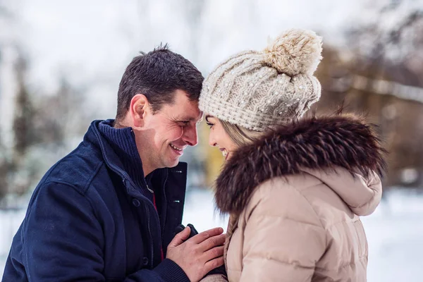 Family, winter holidays, Christmas and people concept  Young romantic couple is having fun outdoors in winter