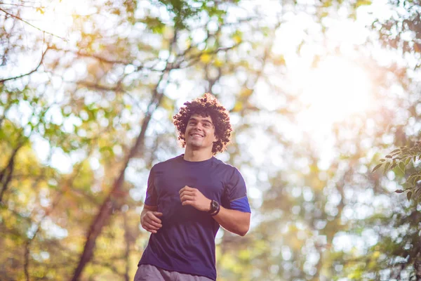 Young fitness Man running at the nature- fitness, sport, training and lifestyle concept