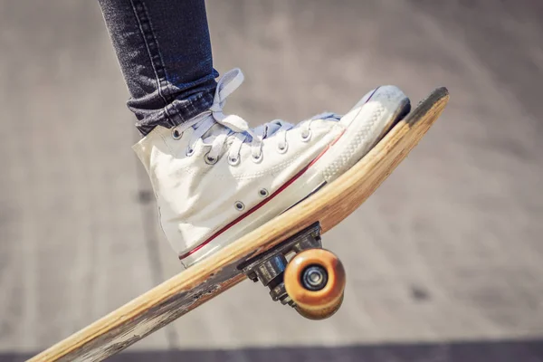 skateboarder legs on skateboard at skate park
