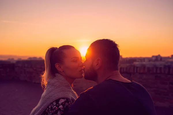Couple in love kissing at evening  in sunset