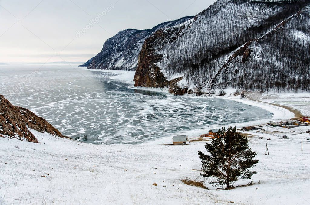 View of winter landscape in Siberia with frozen lake Baikal in the distance from the top view. Winter in Russia