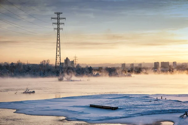 Winter Angara. The city embankment of the Angara River on a Sunday sunny winter day with fog. Winter Irkutsk
