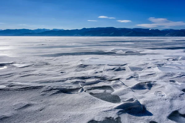 Het Baikalmeer is bedekt met ijs en sneeuw, sterk koud, dik helder blauw ijs. Het Baikalmeer is een ijzige winterdag. — Stockfoto