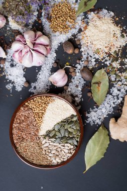 Baharatlar ve tuz kaşık siyah arka plan, tohum. baharat. Renkli doğal katkı maddeleri.