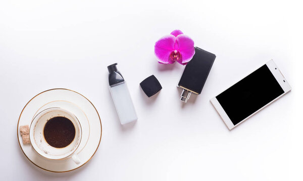 cup of coffee with smart  phone and lady care set around white b