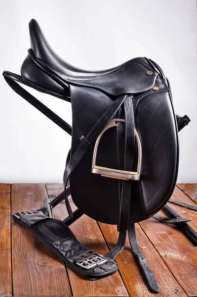 Black professional  leather dressage saddle with stirrups — Stock Photo, Image