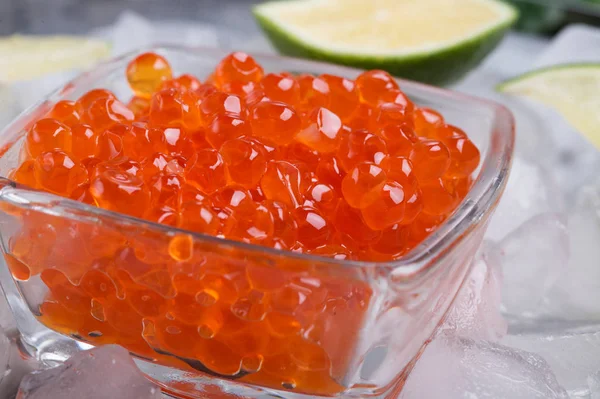 Färsk röd Laxkaviar med lime runt is. makrobild. Pro — Stockfoto