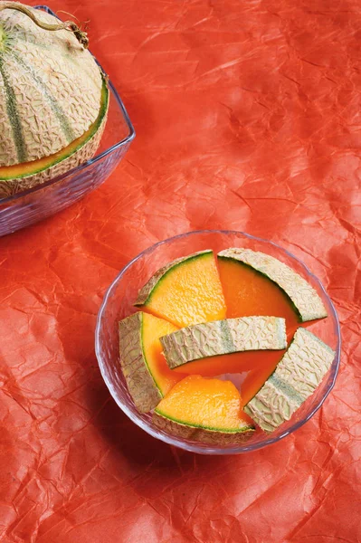 Melone melone affettato intorno sfondo arancione. gustoso dolce ex — Foto Stock
