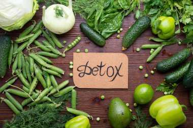 detox green vegetables lifestyle  concept. various fresh green vegetables at wooden table. flat lay