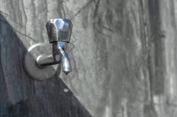 Water drips from a tap