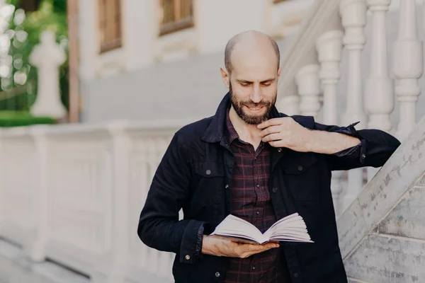 Handsome Clever Bald Male Holds Book Reads Interesting Novel Serious — Stock Photo, Image