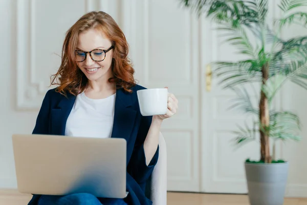 Optimistic Red Haired Young Successful Female Freelancer Works Remotely Coworking — Stock Photo, Image