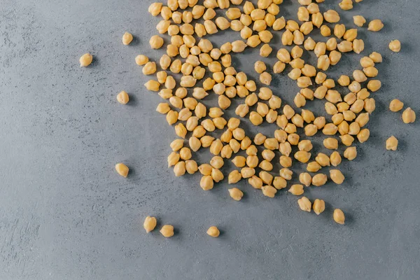 Close up shot of dry chickpeas on grey background. Raw vegetarian food. Healthy dieting concept. Natural vegan food. Clean garbanzo — Stock Photo, Image