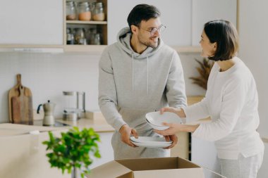 Memnuniyetle ev hanımı ve kocası yeni sofra takımlarıyla birlikte karton kutuları açarlar, tabak taşırlar, yeni bir daireye taşınırlar, birbirlerine sevinçle bakarlar, agaist mutfak içi pozları verirler. Yeniden yerleştirme konsepti