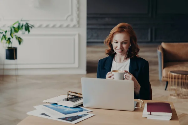 Glad Red Haired Woman Has Distance Job Communicates Video Chat — Stock Photo, Image