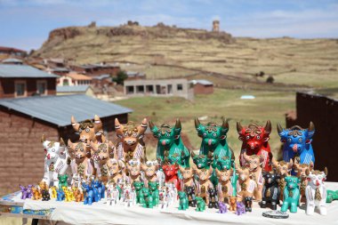 Sillustani, Peru  October 25, 2018: Bull Figurines called Torito de Pucara. A popular Souvenir for Tourists in Peru. clipart