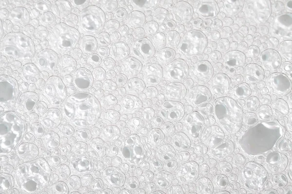 White foam bubbles from shampoo as background