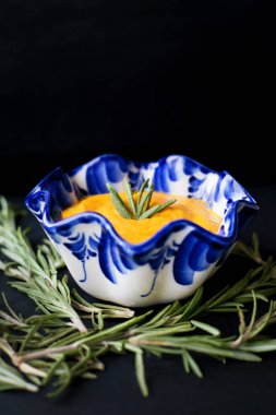 dal biberiye, siyah bir zemin üzerine balkabağı çorbası yakın çekim