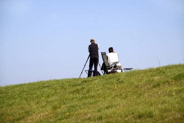 Hollanda, Noordoostpolder, Temmuz 2017: bir dike üzerinde kuş gözlemcisi
