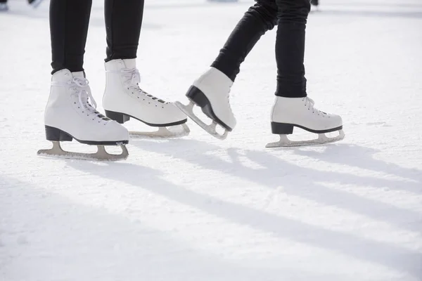 Women ice skating on ice rink