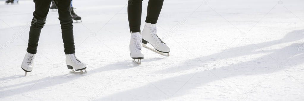 Women ice skating on ice rink