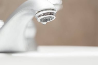 Damlayan suyu olan banyo musluğu. 