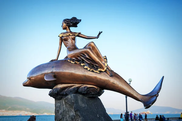 Een meisje dat een dolfijn monument in Novorossiysk rijden — Stockfoto