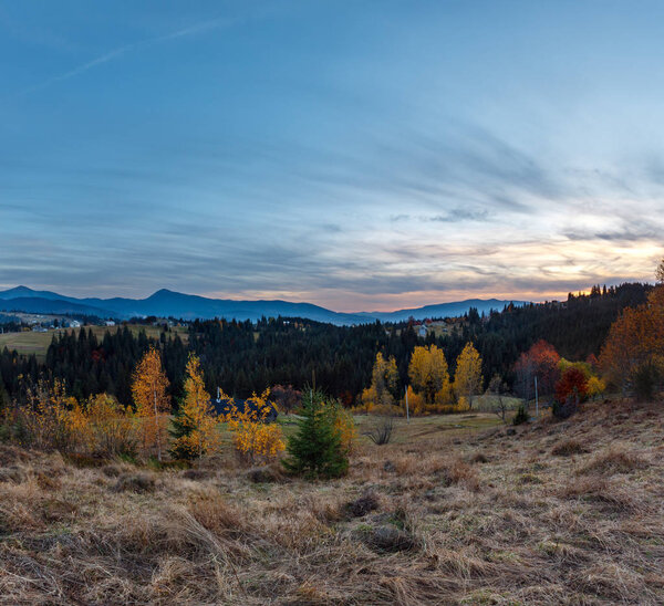Evening twilight Carpathian mountains and village hamlets on slopes (Yablunytsia village and pass, Ivano-Frankivsk oblast, Ukraine).