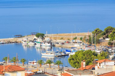 NEOS MARMARAS, GREECE - JULY 25, 2016: Summer morning coast view (Halkidiki, Sithonia, Greece). clipart