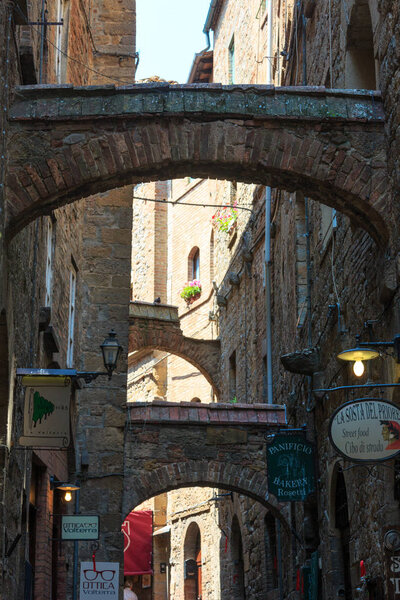 VOLTERRA, ITALY - JUNE 24, 2017: Summer ancient walled mountaintop town Volterra street scene, Pisa province, Tuscany, Italy.