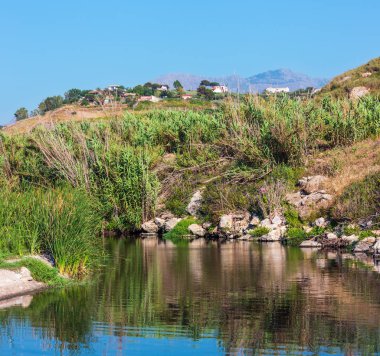 Çakıl plajı denizde küçük nehir akar. Kuzey Sicilya Tiren Denizi kıyı şeridi, İtalya.