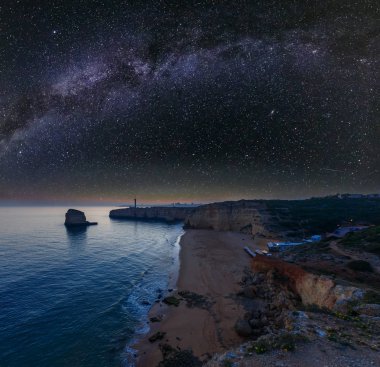 Gece deniz kıyısı ve yıldızlı Samanyolu